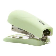 a green stapler sitting on top of a white surface