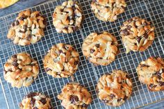 cookies are cooling on a wire rack with nuts and raisins in the middle