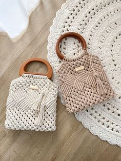 two crocheted purses sitting on top of a white doily covered floor