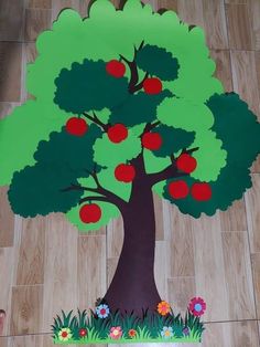 a paper cut out of a tree with apples on it