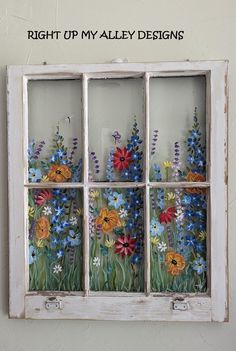 a window with flowers painted on it and the words right up my alleyy designs