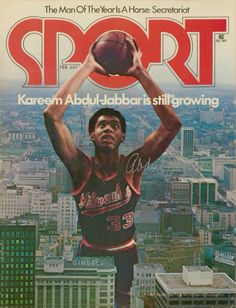 a magazine cover with a basketball player holding a ball above his head in the city