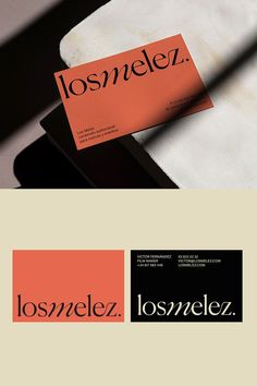 an orange and black business card sitting on top of a piece of paper with the word los