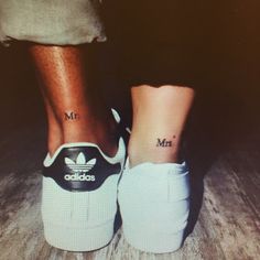 two people with matching adidas shoes on their feet, one has the word mr and mrs tattooed on it