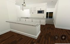 an empty kitchen with white cabinets and wood flooring