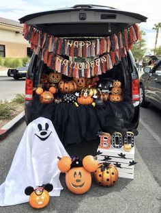 the back of a van decorated for halloween with pumpkins and jack - o'- lanterns