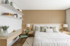 a white bed sitting next to a window in a bedroom