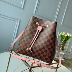 Description L.V NeoNoe Bucket Bag Damier Ebene Canvas Venus Pink For Women,  Shoulder And Crossbody Bags 10.2in/26cm LV N40198 Rep 1:1 The NéoNoé bucket bag is fashioned from Damier Ebène canvas, accented with colorful details such as its drawstring and matching bonded lining. This lightweight and body-friendly bag can be worn cross-body or over the shoulder with a long or short drop, thanks to its adjustable strap. The inside zipped pocket keeps valuables safe. Size: 26 x 26 x 17.5 cm / 10.2 x 10.2 x 6.9 inches (Length x Width x Height) Venus Pink Damier Ebène coated canvas Microfiber lining Gold-color hardware 2 compartments Zipped central flat pocket Drawstring Metal eyelets Strap: Removable, adjustable Include box, dust bag. This product is of the best quality. Lv Neonoe, Louis Vuitton Neonoe, Damier Ebene, Aaliyah, Replica Handbags, Images Gif, Louis Vuitton Handbags, Wallet Case, Louis Vuitton Monogram