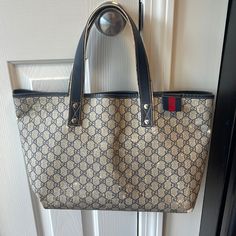 This Is Your Go-To Classic Gucci Tote/Over The Shoulder. It’s Tan With Navy Monogramming. Canvas Coated / Leather Material Please See All Pictures. It Has Significant Wear And Tear. There Are No Rips Or Tears.Ink Mark On The Inside Pocket. *See Pic Some Areas Have Leather Worn Down And Fading. Ask Me Anything. Thanks!! Pre-owned Gucci Bags For Shopping, Gucci Gold Tote Shoulder Bag, Gucci Gold Tote Bag, Gold Gucci Tote Bag, Gucci Gold Shopping Bag, Gold Gucci Shopping Bag, Gold Gucci Bag For Shopping, Gucci Gold Monogram Canvas Bag, Gucci Tote Bag