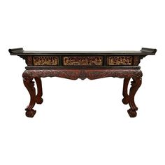 an ornate wooden table with two drawers