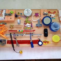 a wooden table topped with lots of different types of toys and gadgets on top of it