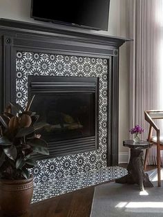 a living room with a fireplace and tv above it