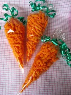 three carrots wrapped in cellophane and tied with green ribbon