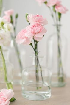 three vases filled with pink and white flowers