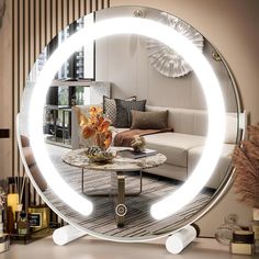 a living room scene with focus on the coffee table and large circular mirror in the middle