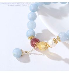 This elegant color stone bead bracelet features light blue aquamarine beads, 7 mm bead diameter, with a dangle drop bead, gold metal bead cap as an accent, on elastic band for easy fitness. Add this elegant bead bracelet to your everyday fashion jewelry collection or as gift for your love one. Jewelry Care: See more information about how to care for your jewelry here. Shipping Policy: Orders will be shipped within 1-3 business days. Economy shipping will take 7-14 days to arrive and standard shi Elegant Light Blue Jewelry With 8mm Beads, Elegant Charm Bracelet With Round Beads For Healing, Elegant Aquamarine Beaded Bracelets, Easy Fitness, Metal Bead, Aquamarine Beads, Elegant Color, For Your Love, Drop Beads