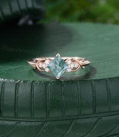 a close up of a ring on top of a green tire rim with diamond accents