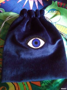 a blue bag with an evil eye on it