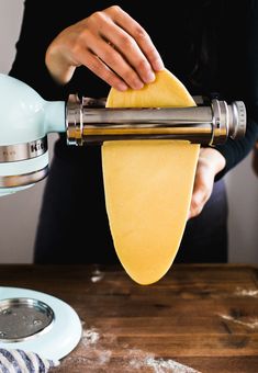 a person using a hand mixer to make cheese