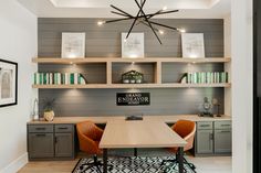 a dining room table with chairs and bookshelves on the wall behind it in front of a bookcase