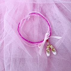 A gorgeous ballet charm bracelet for the little ballerina in your life!  Three beaded bracelets each in a different shade of pink joined together and finished off with with cute ballet shoes charm, and a pretty pink ribbon. Handmade Flexible Pink Bracelets, Pink Beaded Bracelets For Gift, Pink Flexible Beaded Bracelets For Gifts, Flexible Pink Beaded Bracelet, Flexible Pink Beaded Bracelets, Shoes Charm, Pink Charm Bracelet, Gorgeous Birthday, Pink Charm