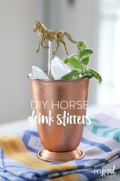 a copper cup filled with ice and a horse figurine sitting on top of it