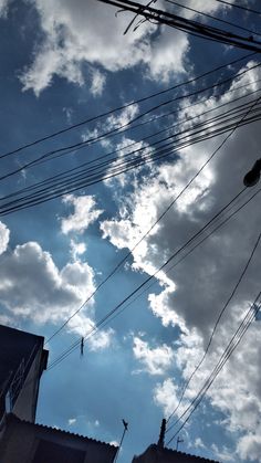 the sky is filled with clouds and power lines