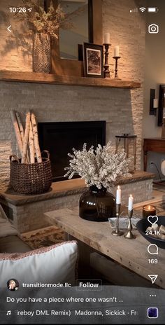 a living room filled with furniture and a fire place in front of a stone fireplace