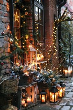 many lit candles are lined up on the side of a brick building with christmas decorations