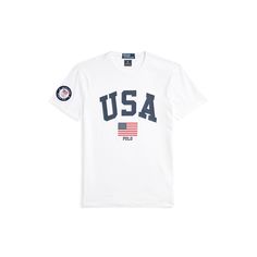 Part of the Polo Ralph Lauren Team USA Collection this Custom Slim Fit T-shirt features an official logo patch of the U.S. Olympic Team as well as an archival-inspired graphic that includes “Polo” and the American flag. Short Sleeve T-shirt With Logo Emblem For Streetwear, Crew Neck T-shirt With Logo Emblem For Streetwear, Cotton T-shirt With Logo Emblem For Streetwear, White Short Sleeve Top With Logo Patch, Collegiate Cotton T-shirt With Logo Print, White T-shirt With Logo Patch, White Crew Neck T-shirt With Logo Patch, Classic Letter Print Tops For College, White Graphic Tee With Logo Patch