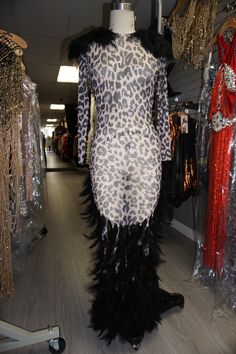 Animal print mesh dress with black feather accents. The dress is sheer but has great stretch. We've also embellished the dress with rhinestones to give it some sparkle. The feathers are draped down in a U-shape to the floor. Feathers are also on the shoulders. The dress has a zipper in the back making it easy to put on and very comfortable to wear. - Mesh material (see through) - Dress is not lined - Stretchy 3/3 Model's body measurements are: Bust 34D, waist 26, hips 41. Height 5'1, 5'5 with he Black Cocktail Dresses With Ostrich Feathers, Black Ostrich Feather Cocktail Dress, Ostrich Feather Dress For Night Out, Ostrich Feather Night Out Dress, Glamorous Feathered Cocktail Dress, Night Out Dress With Ostrich Feather Trim, Glamorous Sequin Feather Dress For Night Out, Glamorous Feathered Sequin Dress For Night Out, Sequin Dresses For Glamorous Party Events