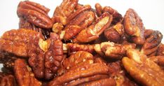 a pile of pecans sitting on top of a white table next to each other