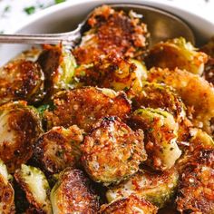 a bowl filled with cooked brussel sprouts and topped with seasoning