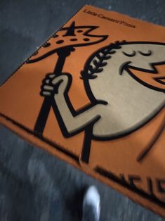 a close up of a sign with a cartoon character holding a baseball bat on it