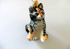 a ceramic cat ornament hanging on a wall