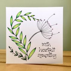 a greeting card with an image of a dandelion and the words, with heart - shaped sympathy