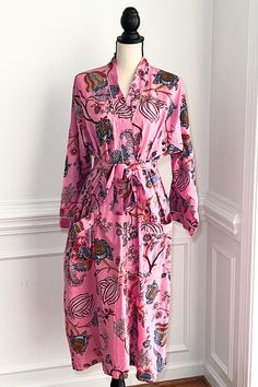 This robe is more than just loungewear; it's a statement piece that combines comfort with fashion. The ankle-length dressing gown provides a cozy and stylish layer, whether enjoying a laidback morning with a cup of tea or winding down in the evening after a joyful day of holiday celebrations. The Kimono Robes showcase vibrant artistic prints on 100% soft cotton fabric. Artisans in Rajasthan, Indian print the fabric is print dyes are  eco-friendly dyes. These beautiful cotton robes come with larg Printed Pink Sleepwear For Home, Cotton Sleepwear With Kimono Sleeves For Loungewear, Cotton Sleepwear With Kimono Sleeves, Pink Printed Sleepwear For Home, Spring Cotton Kimono For Lounging, Cotton Kimono For Spring Lounging, Spring Kimono With Relaxed Fit, Long Sleeve Robe For Lounging, Pink Cotton Nightgown For Lounging