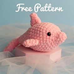 a pink crocheted stuffed animal sitting on top of a white box with the words free pattern above it