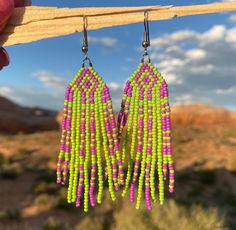 Handcrafted seed bead earrings, made by hand in our Colorado jewelry studio.  Purple and Green Beaded Fringe Earrings. Hand Crafted using glass seed beads. Stainless steel hook ear wires. Southwest, Western and Desert boho style. Limited Edition. Check out our other styles and follow us on Instagram to see what is new @monstera_metalworks Southwestern Green Earrings With Dangling Beads, Southwestern Green Earrings With Colorful Beads, Southwestern Style Green Earrings With Colorful Beads, Southwestern Green Beaded Dangle Earrings, Handmade Southwestern Green Beaded Earrings, Southwestern Green Beaded Dangling Earrings, Desert Jewelry, Earrings Handmade Boho, Desert Boho