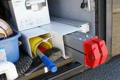 the inside of a van with hoses and other items in its storage compartment on the side