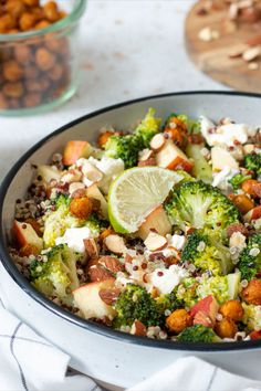 a bowl filled with broccoli, cauliflower and other food on top of a table