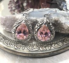 Pink CZ Teardrop Earrings Description E30 Teardrop design MADE TO ORDER This is a brand new Art Nouveau/Victorian-inspired filigree sterling silver pair of teardrop Pink CZ gemstone earrings. The gorgeous 12ctw Gems are 16mm (5/8th of an inch) by 12mm (1/2 inch) in size each. The earrings are 1 11/16th inches long by 13/16th of an inch wide. Notice the beautiful swirl like the craftsmanship of the silver filigree settings. This is a well made beautiful pair of silver earrings and they are ready Filigree Drop Jewelry For Anniversary, Pink Teardrop Earrings For Anniversary, Pierced Pear-shaped Teardrop Earrings, Pear-shaped Teardrop Earrings As Gift, Anniversary Drop Teardrop Earrings, Pierced Teardrop Anniversary Earrings, Sterling Silver Filigree, Cz Earrings, Big Earrings