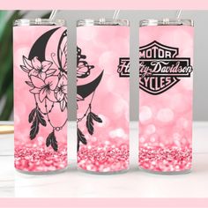 two pink flasks with black and white graphics on them, sitting next to each other