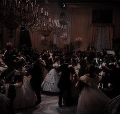 a black and white photo of people dressed up in formal dress dancing at a party