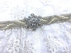 the bridal belt is adorned with crystal and pearls