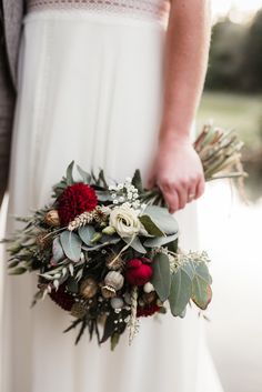 a close up of a person holding a bouquet