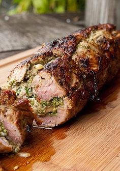 a large piece of meat sitting on top of a wooden cutting board