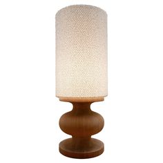 a wooden table lamp with a white fabric shade on the top and bottom part of it