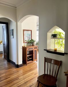 a room with wood floors and white walls