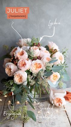 a vase filled with lots of flowers on top of a wooden table